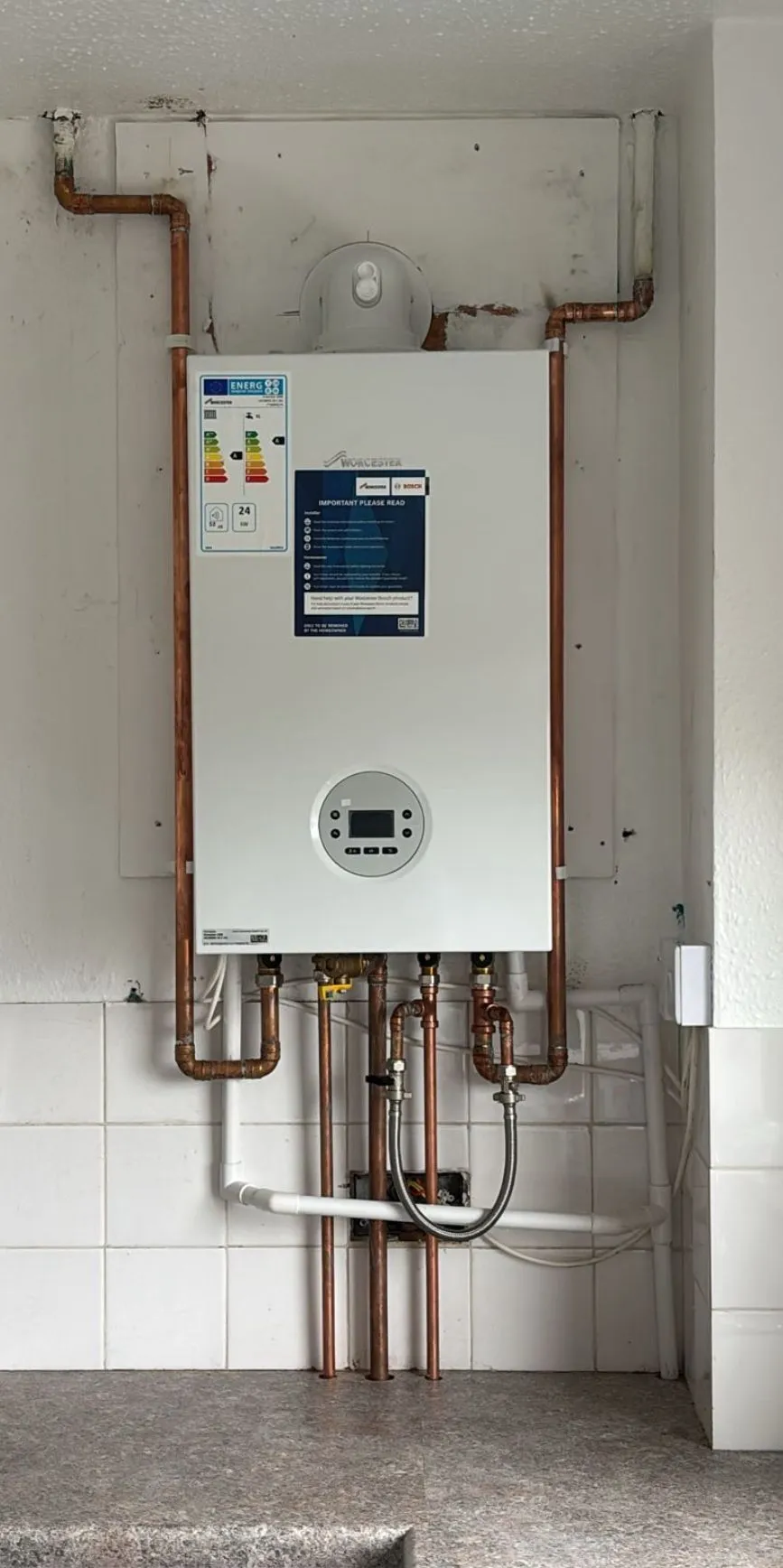 Technician relocating boiler in London